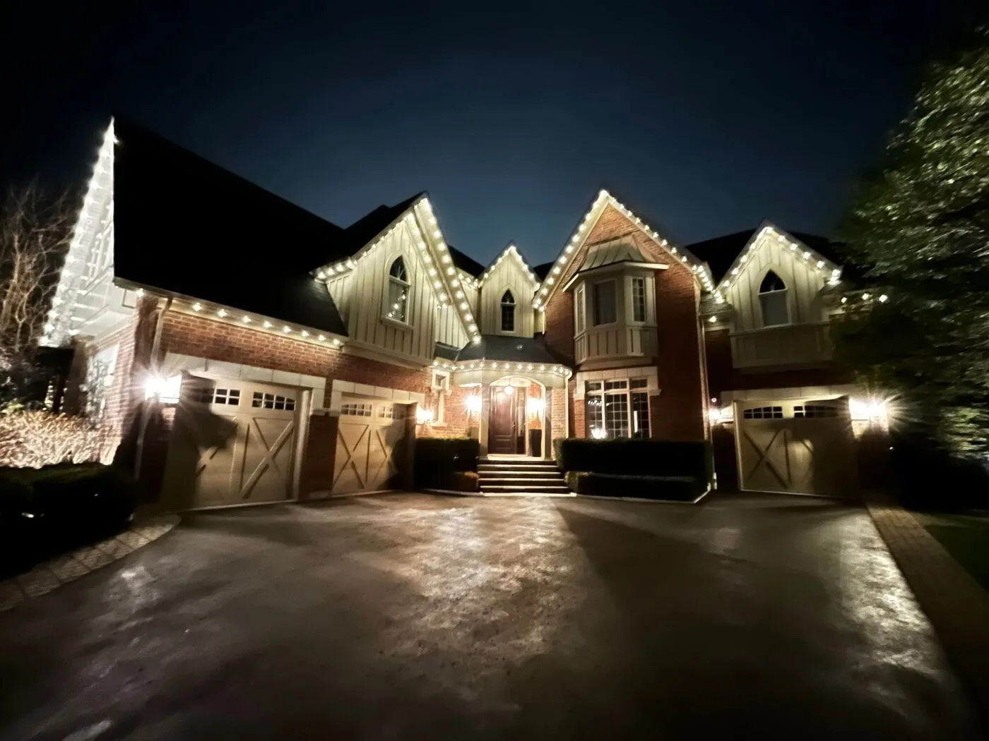 Vancouver home with warm white permanent LED roofline lighting at night