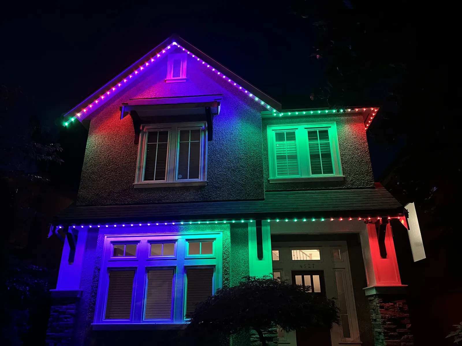 Vancouver home illuminated with green, red, purple, and blue permanent LED lighting zones