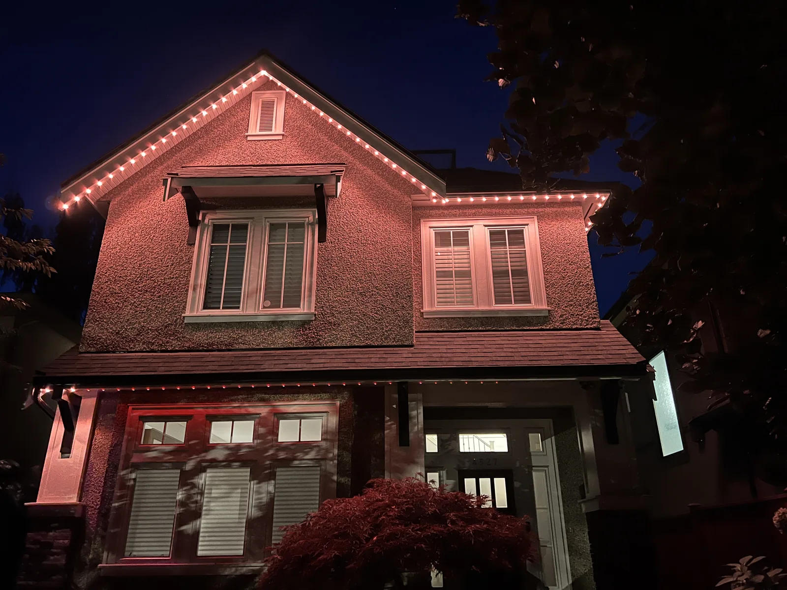 Vancouver home glowing with single-colour red permanent LED roofline lighting