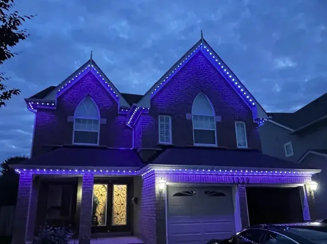 Permanent LED lights installed along the roofline and soffits of a Vancouver home at night