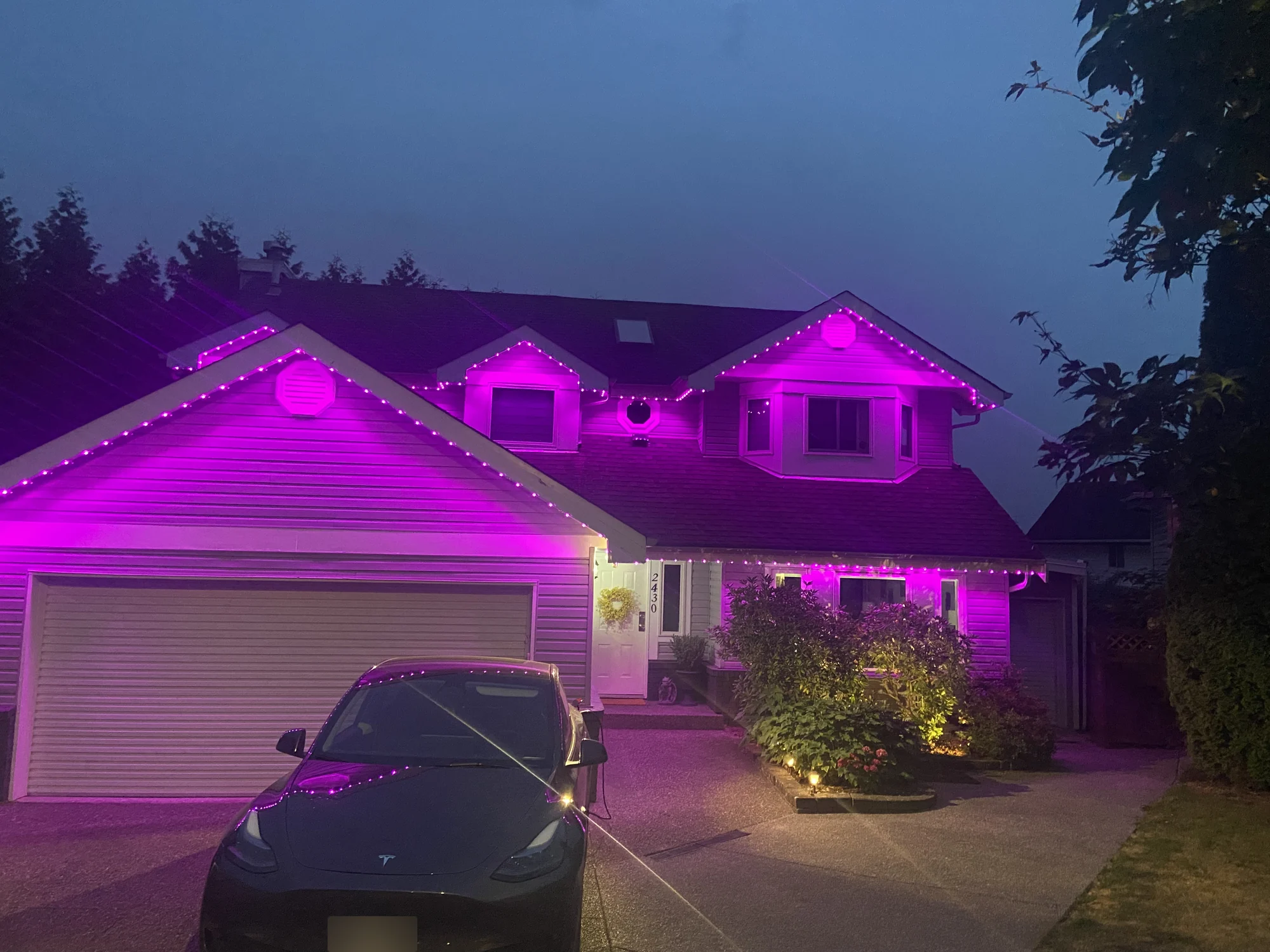 Vancouver home with magenta and purple permanent LED roofline lighting at dusk