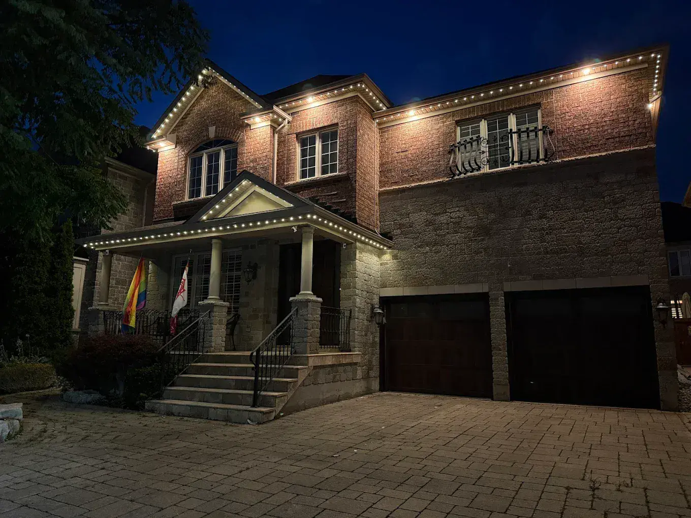 Brick home with warm white permanent LED soffit and roofline lighting